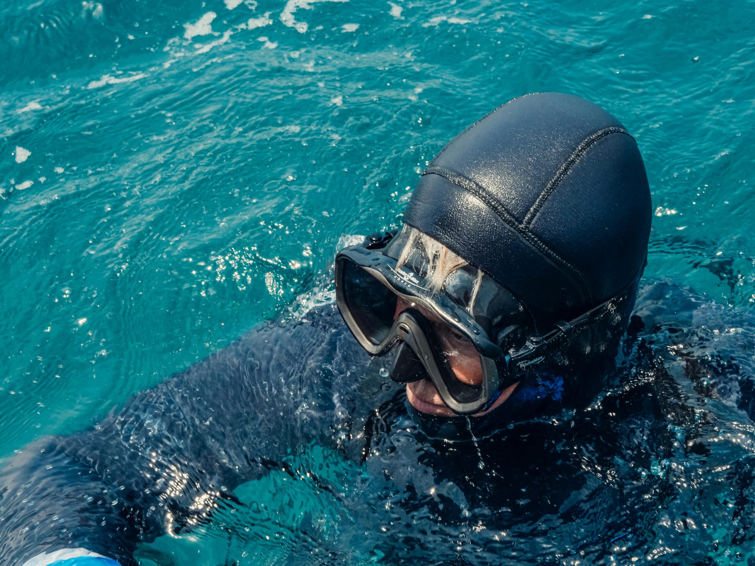 pexels photo 8849696 8849696 Close-up of a scuba diver in a wetsuit wearing goggles in the ocean.